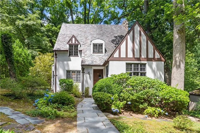 Nestled on a quiet street in the prestigious Old Edgemont neighborhood this classic Tudor offers the perfect blend of charm and character. Conveniently located, it is a short walk to Crane Pond, Elementary and High Schools, Scarsdale Metro North and Village. This home provides easy access to shopping, dining and trails. Upon entering you are greeted by an inviting living space. The living room with its wood burning fireplace seamlessly connects to a cozy den, a formal dining room and eat-in kitchen with newish appliances and with door to patio. The bedroom and full bathroom on this floor are well appointed for guests or a home office. The second floor offers a primary bedroom with an ensuite bathroom, a second spacious bedroom with a walk-in-closet. a third bedroom and a hall bath. The basement level is walk out to back yard and garage. The property is screened by mature trees and bushes providing privacy year round. Don&rsquo;t miss the opportunity to make this lovely residence your own.