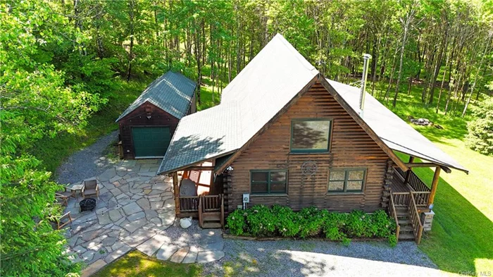 The Covered Wagon Cabin in Parksville, NY is the creme de la creme of upstate cabins. Set on 50+ acres this bonafide log home is everything you would expect when you envision an upstate getaway. The location is quiet, peaceful and private and a short drive to the highway for easy access. There are multiple garage and storage buildings for all the toys and atv&rsquo;s.  The house itself is serious quality construction. The smell of cedar radiates throughout and a total of two bedrooms, full bath and open kitchen/dining/living room with wood burning stove on the main floor. The master with en suite bath in the upstairs loft PLUS a full finished basement with bunk room, game room, and full bath. There are no worries here with the back up generator, central air and the front porch overlooking the private yard and apple orchard. There is a nice stocked pond too with bass and giant catfish. This is a real dream place for the hunter or outdoor enthusiast with a house and property that can be thoroughly enjoyed by everyone.