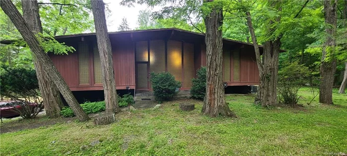 Wesley Hills! Bring your toolbox to this genuine redwood mid-century modern Versland-Rhodes contemporary situated on a very private property. Features large rooms, with original details. HW floors, large windows, deck, lots of light, brick fireplace, full finished walk out lower level with 2 rooms, a half bath plus a 2 car garage and more.