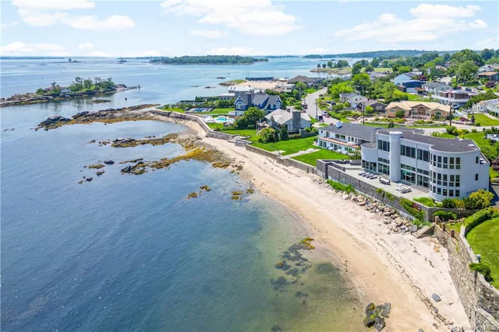 Introducing this iconic waterfront retreat with private sandy beach and uninterrupted views of Long Island Sound that stretch to eternity! An architectural beauty and one of New Rochelle&rsquo;s most notable modernist homes, originally designed in 1982 by famed Myron Goldfinger and then expanded in 1999, quietly nestled within an exclusive gated community of only 12 properties, just 35 minutes from NYC. A world unto itself that&rsquo;s as close to paradise as you&rsquo;ll get. Featured in numerous magazines this dramatic sculptural stunner pairs modern simplicity with a Malibu-cool lifestyle. Swim, kayak and paddle board direct from your private beach, forage for crabs among the rockpools, and enjoy mooring rights for your own boat. Host a soiree for 100 on the grand waterfront patio or a pool & jacuzzi party in the indoor glass-clad room with breathtaking views that&rsquo;s heated for year-round use. Entertaining here is unparalleled! Inside this striking 5, 000+ sq ft geometric fa&#231;ade, fresh white gallery art walls are curved in Mediterranean-esque fashion, intersecting with soaring ceilings dotted with skylights and swathes of glass that blur the boundary between sea and sky. Designed to embrace endless water views from almost every vantage, this sunlit home features two wings with 5 bedrooms connected by magnificent common spaces  living room with sunken conversation pit and fireplace, dazzling dining room, designer kitchen, office and sensational family room that feels like you&rsquo;re floating above the water. The primary bedroom is unlike anything else, quiet bliss and soulful views. A home like no other, the perfect balance of openness and privacy. X-500 flood zone. No flood insurance required.