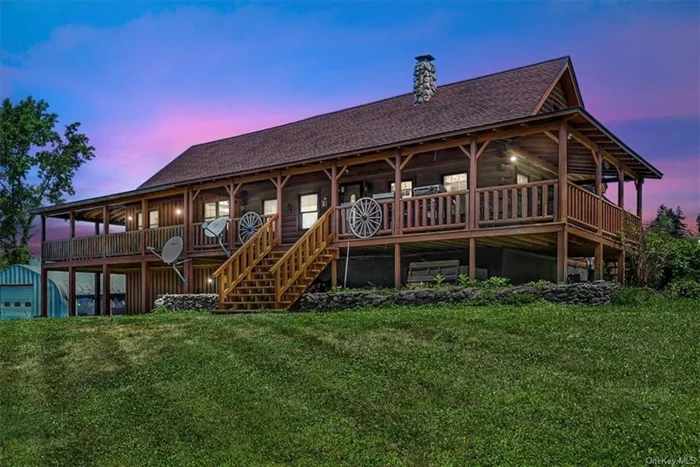 The beautiful log home in the heart of Milton, New York is a sight to behold. Surrounded by lush orchards and vineyards, the house exudes a sense of tranquility and serenity. There&rsquo;s a new two-story addition of a family room with cathedral ceilings, first floor primary bedroom with gorgeous custom tiled full bath, as well as a large three bay garage beneath. Sitting on 5.4 acres of land. The property is spacious and inviting. The large two-story barn to the side of the house adds to the charm of this rural setting. With its wood exterior and rustic features, the barn is the perfect complement to the main house. Inside the home, natural light floods the open concept living space, creating a warm and inviting atmosphere. The wood accents throughout the house gives it a cozy and welcoming feel. The upstairs hosts two cozy bedrooms with full bath, offering views of the surrounding orchards with rolling hills. The primary suite is a private retreat with a luxurious en-suite bathroom and double closets. Outside there is plenty of room for outdoor activities. A large, covered wrap around deck is ideal for sitting back and relaxing, or enjoying your morning coffee, or hosting the perfect summer gathering. There is an additional metal dome shaped space for your hobbies or home business. Overall, this unique property is a true gem. It offers the perfect blend of modern convenience and rustic charm. The beautiful setting and peaceful surroundings make it a truly special place to call home.