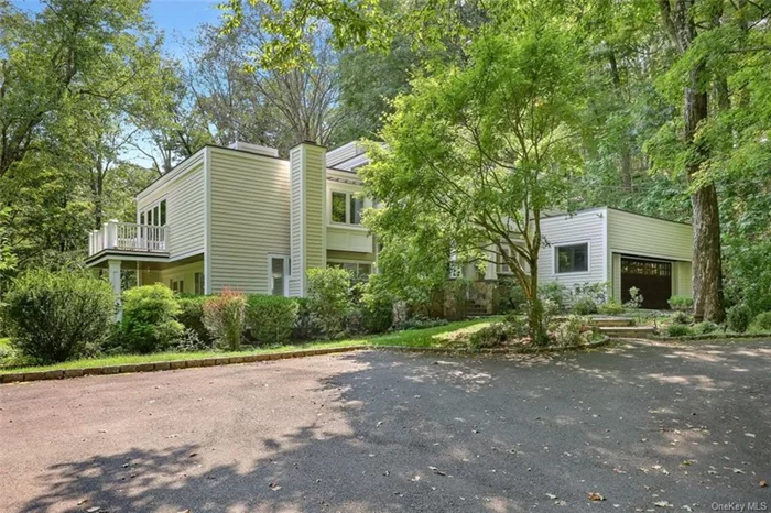 Stunning contemporary home in one of the most desirable, centrally located Pound Ridge settings. Just across from the walking path, effortlessly stroll into town, the parks, and more. YES, it truly is an impressive location. This home is complemented by oversized windows integrating the beauty of nature into every room. HW floors lead you to the walkout living room with an eye-catching fireplace, a treat during colder months. Dream kitchen boasts SS appliances, propane gas cooking(!), custom cabinetry, prep sink, luxurious quartz c-tops & more. Enjoy your morning coffee fr the primary ensuite&rsquo;s balcony or the sun-kissed reading nook. The spacious walk-out lower-level family rm is ready for movie nights, playdates, or whatever merriment you have in mind. Send your Evites, the circular driveway will accommodate many guests while offering complete privacy. A full house generator, TWO(!) well-sized yards, and an EV outlet round off this home in picturesque Pound Ridge.