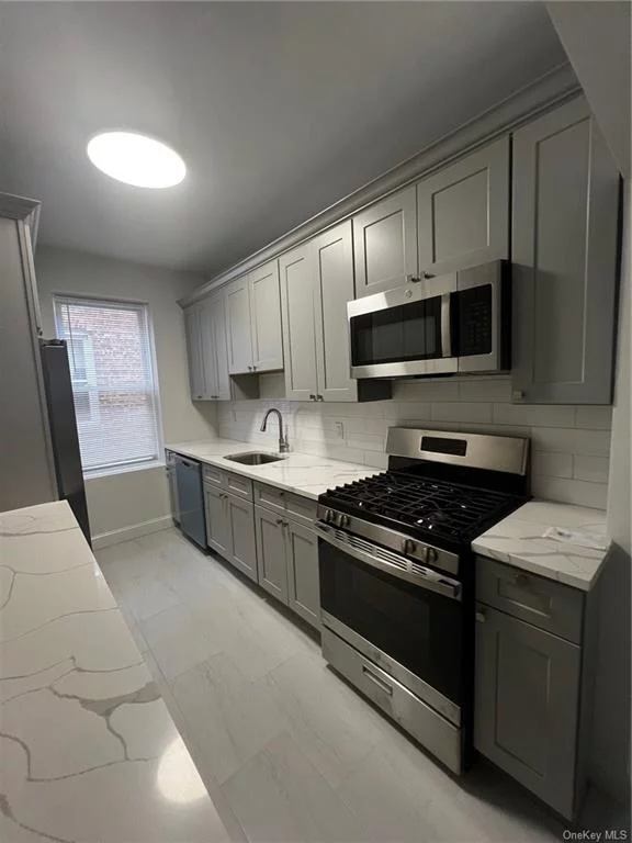 Looking to downsize into a unit that has little steps? Well look no more-Welcome to this GORGEOUS 3 bedroom 1st floor unit that awaits you with open arms in the heart of Morris Park!!! Completely renovated from top to bottom-this rental boasts high ceilings, massive sunroom off the large living room, ample bedrooms that all can hold queen/king size furniture,  a beautiful chef&rsquo;s kitchen with stainless steel appliances & Quartz countertops. The unit also has original hardwood floors that exists throughout the rental. Rent includes cooking gas, heat/hot water & tenant is responsible for electricity. Private parking for 2 cars is available for additional $300 a month. This rental is just a 5 minute walk from the Morris Park 5 train stop & close to all transportation including the express bus. This gem will not last so call today!!