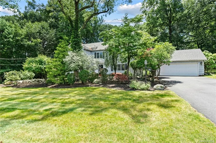 Exceptional North New City Location! Sited on nearly an acre of landscaped grounds, this 5-Bedroom, 2.1 Bath Colonial is set on a quiet street in the Woodlands Estate off Phillips Hill Road. Mature trees, perennial plantings, and natural stone walls provide a gracious &rsquo;country-club&rsquo; setting. Enjoy the feeling of privacy that surrounds you. Red brick pavers lead to the front door, and an elegant foyer welcomes you. With oak hardwood floors throughout and well-sized, sunny rooms, this colonial is easy to love. The thoughtful layout includes a formal living room outfitted with custom library shelving, recessed lighting, French-door sliders to the patio and views of the garden from 3 large windows with a charming window-seat. Enter the formal dining room through the living room&rsquo;s French doors and you&rsquo;ll find a room that can easily accommodate 6-8 and features chairs rails, elegant millwork, and a picture window framing the garden view. The Great Room addition features beamed cathedral ceilings, a wall of windows with views of the garden along with large, full glass doors to the patio. Open the doors and step out into your private backyard with flowering trees and large, gracious paver patio -- the perfect spot for enjoying al fresco dining. The Great Room opens to the Chef&rsquo;s Kitchen which has generous storage & counter space, a peninsula breakfast bar & recent stainless steel appliances, including a Kitchen Aide double-oven, 4-burner stove top, Bosch DW and side-by-side Frigidaire. You&rsquo;ll appreciate the picture window over the double sink. The Kitchen&rsquo;s dining area is a great place for casual meals and convenient to the Great Room. Also on the main level are a powder room and multi-purpose room currently being used as a bedroom/home office. This room could be used as a den or 5th bedroom - you decide! Upstairs, the oversized Primary bedroom has 3 generous closets and a completely updated en suite bath with ceramic tiling in a soft grey palette, a huge walk-in shower w/seat, and a double vanity with marble counter & lots of storage. Also upstairs are 3 additional bedrooms, another updated full bath with classic subway tiling, and a convenient laundry shoot. The walk-up attic provides tremendous storage and also includes a small, finished room -- great for quiet study or a playroom. There is a detached, 2-car garage and a long, wide driveway that can easily accommodate 8 cars. The offering also includes a whole house generator. Take the path from the garage to the house or your backyard oasis. A distinct buying opportunity convenient to the Palisades Parkway and 45 minutes to Manhattan.