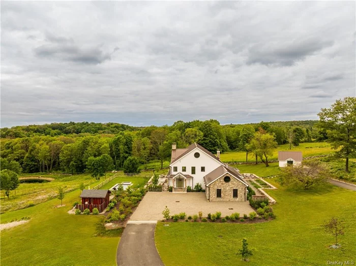 TURNKEY IN MILLBROOK: A discreet tree-lined drive with expansive views of two ponds and rolling hills leads to this stunning modern farmhouse. Sitting on 10 exquisitely manicured acres with an in-ground pool and spa, 3585 Route 82 is the perfect weekend retreat or full-time home. Flanked by gardens reminiscent of the English countryside, tasteful finishes, custom millwork, generous proportions, and breathtaking views complete the package. An elegant entrance leads to a gracious foyer and a grand living room beyond it with a wood burning fireplace overlooking the beautiful view. Slide open the doors to the pool area for indoor/outdoor living at its peak. The chef&rsquo;s kitchen is equipped with a 4-door Samsung refrigerator, a Bertazzoni free-standing vintage range, a microwave, multi-wall and steam ovens, and a warming drawer. An integrated hood is set against a hand-made Zellige tile backsplash. The dining area features a wall of custom cabinets and a bar by renowned English cabinet maker deVol, and creates a natural separation for the ample office/den and fitness room at the rear of the house. The first-floor luxurious primary suite wing adjacent to the great room enjoys amazing westerly sunset views over the foothills of the Berkshires. The primary bedroom features a fireplace, walk-in closets, and a large bathroom with a walk-in shower, deep freestanding spa tub, inlaid marble floors and a state-of-the-art Toto toilet. The chic deVol-designed laundry room is also located on the first floor, as well as a jewel box powder room. The 2-car garage is accessed through the mudroom adjacent to the garage entrance. The gym and office with its cozy fireplace complete the 1st floor. There are 3 generous ensuite bedrooms upstairs including a luxurious 2nd primary, each with walk-in closets and perfectly framed vistas. The 2nd level boasts a cozy media room, which doubles as a 5th bedroom with a full bathroom adjacent to it. The pool area features a built-in outdoor kitchen with a bbq and pizza oven and bluestone patio. A French lavender garden leads to a second outdoor lounge. The studio building replete with a full kitchen and bath provides additional guest, office, or artist&rsquo;s studio space. As if that weren&rsquo;t enough, the full, dry basement with a temperature-controlled wine cellar, and the full floor attic with high ceilings are your ultimate recreation spaces. This turn-key Millbrook gem, protected by majestic farmland, is perfectly located a stone&rsquo;s throw from the village.