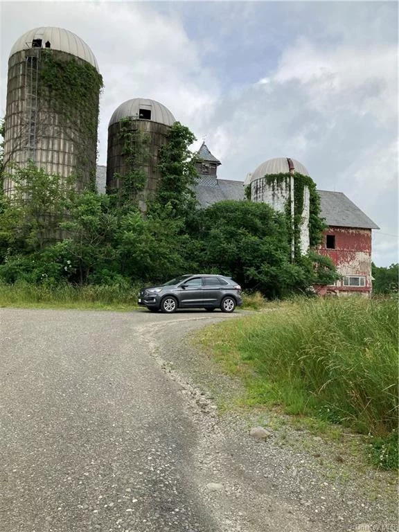 Location Location! Farm with 86.79 acres. ten minutes to route 84. twenty minutes to Middletown and route 17. was an active dairy and horse farm. Large barn with 12 individual horse stalls. large steel building concrete floor. could store farm machinery. if you&rsquo;re a contractor would be a great building to house your heavy equipment and trucks. or a packing house for harvested crops? the land is suitable for growing many types of crops. I have soil type data available. Another metal building open on one side. to back in mowers and other equipment. another building used as a dog kennel with fenced in outside run area. And a older home. built in 1865 Seller selling the farm. buildings and land seller has some personal contents he will keep rest to be determined before closing. Other sheds and out buildings. cleared land about 83 Acres 3 Acres with house barn. buildings.Possible subdivision? Many uses to explore. seller selling as is condition. Minisink Valley School Distric