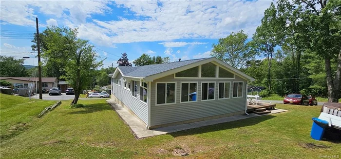 Neat and clean Ranch home! This cute renovated home features an open floor plan with high ceilings, beautiful tile in kitchen and bathroom, wood floors throughout the home. Enter through the wonderful sun room with lots of space, eat-in kitchen, large living room, three bedrooms and a full bath. There is also a full basement with laundry hook up. Sit and relax on the side deck. Nice setting on a corner property that is mostly open lawn with a few mature trees. Don&rsquo;t miss out on this lovely home!