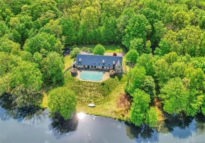 Step into the timeless elegance of this antique French Normandy house, a masterpiece that spans more than two centuries of history. Situated on 73 acres of romantic and undulating land, this unique estate offers a rare blend of privacy and charm, with the centerpiece being the 9.5-acre Heintein Pond, stretching a half-mile and teeming with both natural and stocked fish. A two hundred year old French Normandy home was meticulously dismantled and reassembled by two French teams and one American team over three years. The famous roof slates from Angers, France, as well as the imported windows, doors, stairs, and even the foundation stones contribute to the authenticity and grandeur of this historic home. As you enter, the living room welcomes you with its timeless charm, bathed in natural light streaming through the imported windows. The family room, a cozy retreat, reflects the dedication of the artisans who reconstructed this space with meticulous care. The dining room sets the stage for sophisticated gatherings, while the beautiful country kitchen provides ample space for creating recipes and memories. Three luxurious bedrooms offer private sanctuaries, each showcasing the unique character of this historic residence.  Ascend to the loft space, a versatile area that can serve as a haven for relaxation or entertainment, offering an additional layer of charm to this one-of-a-kind estate. Surrounded by cherry, pear, and apple trees in the tradition of a typical Normandy house, the property exudes a sense of heaven for those with a discerning taste. Built on land previously inhabited by an Italian Countess, whose country home from 1910 still graces the grounds, this estate is a true idyllic landmark. Located approximately 70 miles from New York City, the property benefits from favorable zoning for various uses. Planning board approval opens doors to possibilities such as Bed & Breakfast, Hotel, Camps and Campgrounds, Multi-family dwellings, and more. This mini estate seamlessly blends history, luxury, and natural beauty a haven for those seeking a truly exceptional estate.