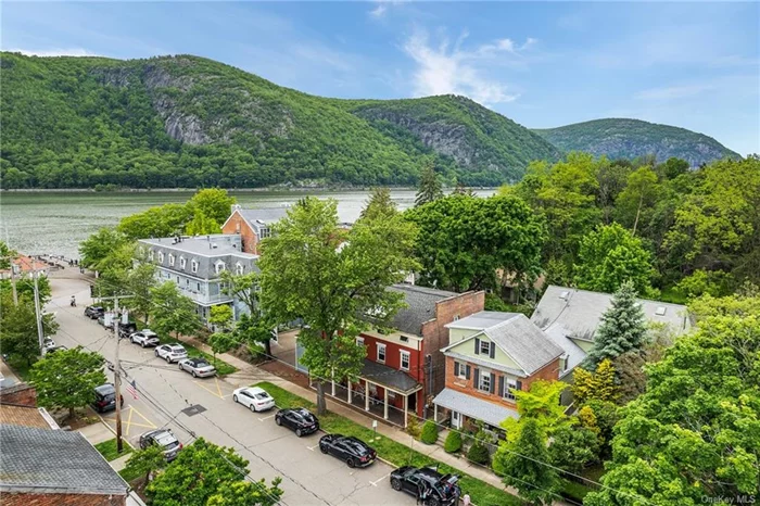 MIXED-USE BUILDING. LOCATION  LOCATION! This one of a kind offering is located on lower Main Street and is just a few feet to the train, riverfront and all that the historic village of Cold Spring has to offer with its quaint shops, eateries and small-town vibes. This property features a charming front porch colonial built in 1880 (@ 14 Main Street) with one residential unit consisting of 3 levels with 2 BR, 1 Bth and Laundry. It also features a 3-story office space built in 2002 consisting of about 4, 000 sq ft with many versatile spaces including a separate executive suite with a full bath, kitchen area, front facing conference room and 2 additional bathrooms on the main level and another bathroom on the second level). The office space is easily accessible (@ 10 North St) with a separate rear entrance surrounded by plantings and enchanting pathways, handicap entrance on the side and an additional 14 car parking lot, which is included in the sale and easily accessible to the river with end of the block access. The possibilities are endless with this fabulous investment offering to customize this amount of space to your own liking to live, work and/or have an income to help pay your expenses, has potential for retail space too! Don&rsquo;t miss this rare opportunity to own a piece of history in the heart of the Hudson Valley and all it has to offer!