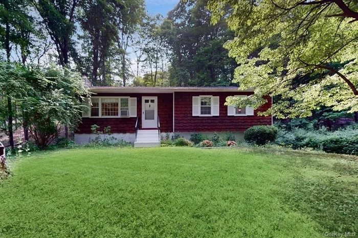 This cheerful charmer has the best of both worlds: a private, woodsy feel and easy access and proximity to the village of Cold Spring. In addition to the spacious living room with working fireplace there is a 250 square foot three-season sunroom with a cathedral ceiling, exposed beams and views of the trees and rock outcroppings. The kitchen is brand new and features honed quartz countertops, Samsung stainless steel appliances and tile backsplash. The full basement has high ceilings and could also add square footage to this home with an easy finish. This is a must see! It&rsquo;s great already, green and lovely, and has so much potential! It boasts hardwood floors throughout, a new roof and low maintenance cedar siding.