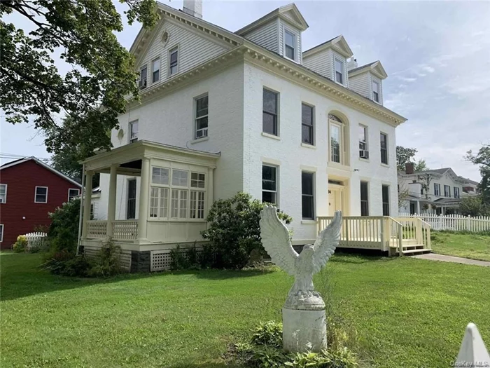 Enjoy gracious village living in this spacious, light-filled 1898 home located a few blocks from the heart of historic Saugerties or use all or part of the property for short-term rentals. Built in the Federal style, this lovely multi-story home features 5 bedrooms, 2 full baths, and 2 half-baths along with an attractive 1-bed, 1-bath accessory apartment with separate entrance. For the past three years, both the main home and the apartment have been available for short-term rentals for family reunions, vacationers, and people participating in nearby HITS competitive horse shows. Hardwood floors and tall windows enhance the home&rsquo;s beautifully proportioned rooms, while North-facing windows on the upper floors provide views of the Catskills. The main home&rsquo;s front door opens to a central hall flanked by two grand living rooms. There are fireplaces in two rooms off the well-appointed kitchen, ideal for relaxing when the air turns cooler. Imagine logs crackling on an autumn afternoon after you or your guests have visited a pumpkin patch or apple orchard. Or imagine reading by the fireplace in an overstuffed armchair as snow falls outside. A half-bath completes the downstairs. A graceful curving staircase with period details leads to the second floor, where one of the three generous bedrooms contains yet another fireplace. This floor includes one full bath with a clawfoot tub, a half-bath, and a large laundry room. Another staircase leads to the third floor, where two bedrooms and a sizable bonus room are located. This floor includes one full bath, also with a clawfoot tub. For those using the home as a residence, each of the third-floor rooms could serve a different purpose. Possibilities include one or more offices for remote work, a playroom, den, craft studio, or library. This magnificent historic home also features an open-air porch off the kitchen and a screened-in porch toward the back. The 1-bedroom apartment has a deck with room for Adirondack chairs and a grill. Three sides of the property are surrounded by a charming white-picket fence. Public and private schools are nearby. The village of Saugerties boasts an independent bookstore, movie house, music venue, bagel shop, and diner, plus bakeries, chocolate shops, restaurants, cafes, and boutiques. A seasonal farmers market is held across the street near the Saugerties Historical Society and 1727 Kiersted House. Exit 20 of the NYS Thruway is a short 1.5 miles away. The famous village of Woodstock is just over 10 miles. Kingston is less than 15 miles. Local ski spots include Belleayre and Windham. HITS-on-the-Hudson is 1.3 miles away, near the 127-acre Cantine Field sports and recreation complex.