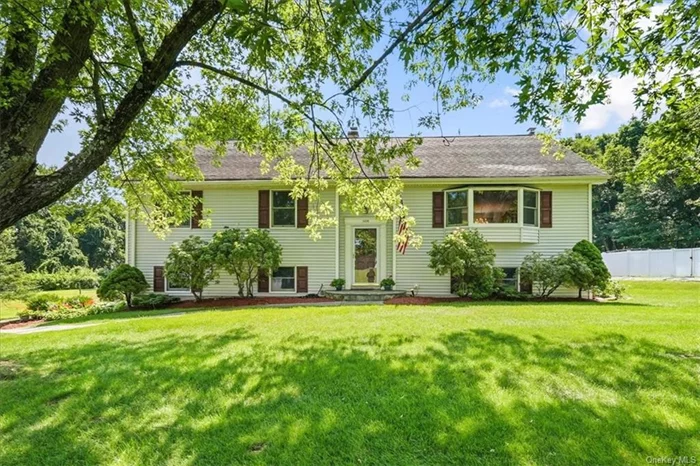 Designed to Delight!! Enjoy the refreshingly roomy living space in this beautifully expanded Raised Ranch nestled on a park like half acre and located in a sought after neighborhood in southern Yorktown. The 2 story expansion and renovation was completed in 2006 and included a very spacious Primary Bedroom suite with a high ceiling, palladium window and balcony access, beautiful primary bathroom with skylights along with new windows, new roof and central air. Hardwood flooring offered under all 1st floor carpeting in Living Room, Dining Room and bedrooms. The lower level is a grand size and includes a wonderful family room with brick fireplace with a sliding glass door out to a stone patio, full bath, bright recreation room including a stylish wet bar and island to entertain and enjoy, office, and laundry/ mud room with separate side entrance. Step out to enjoy the deck overlooking a gorgeous level yard and with a sprawling lawn and lovely mature Magnolia and Weeping Willow trees. This wonderful home offers many options for extended family, work at home, entertaining and spacious living. Great location close to town, shops, restaurants, parkway and short drive to Railroad.