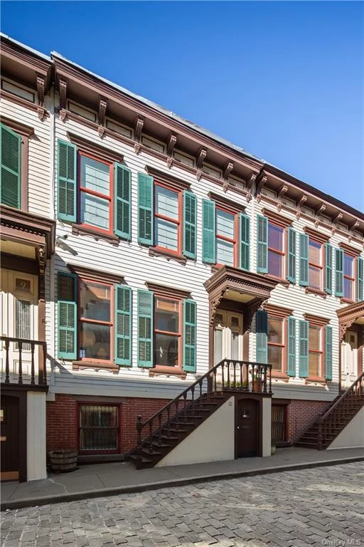 This renovated, over 20 ft wide wood frame townhouse at 11 Sylvan Terrace is only one of twenty landmarked homes as part of the Jumel Terrace Historic District. With extremely low carrying costs, this home can be perfect for a primary resident or investor. ( Only $461/mo. taxes and -$200/mo. energy costs thanks to solar panels on the roof).  The past meets the present in this architecturally designed, beautifully renovated historic row house. The home is 3 stories with a small private outdoor space that has been thoughtfully reimagined. There are 6 room, 2+ bedrooms, 2 1 / 2 baths, an open concept living space on the parlor floor and tons of charm. The home can rented out at a 5% CAP or better. There are no board restrictions as this is a free market, free standing home.