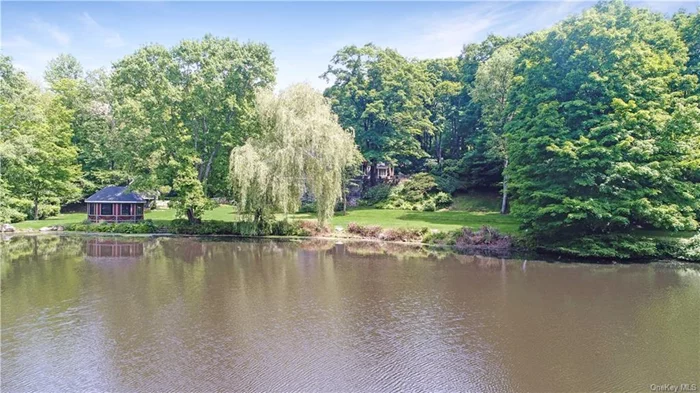 Discover Five Gables On The Lake, a meticulously crafted 1931 lake home, thoughtfully renovated to blend aesthetic elegance with functional perfection on 1.9 acres in Cortlandt Manor, New York. The residence is aptly named for its distinctive architectural feature: five beautifully crafted gable roofs that not only enhance its charm but also define its unique skyline. The first floor serves as an entertainment hub, featuring interconnected spaces, each marked by distinctive features and seamless transitions. The cinema room offers a state-of-the-art audio experience, equipped with six built-in speakers and eight additional connections for Dolby Atmos, providing immersive, theater-quality sound, perfect for movie nights or enjoying your favorite music with breathtaking clarity. Adjacent to this, the stone and slate wine cellar doubles as a tasting area, complete with a Vermont Castings wood stove and a Forno Bravo pizza oven, embodying rustic charm. Completing this trio, the bar area features a custom-built bar and an integrated dining space, opening onto the lower patio which overlooks the verdant yard and tranquil lake. Additionally, the Lower Level includes access to a 2-car garage accommodating 4 cars with maneuverability, another full bathroom, and access to the ground-to-attic stair tower addition, enhancing practicality and convenience.The Main Level is a hub of activity and relaxation, starting with the great room that features vaulted ceilings, wide board paneling, and period details like arched doorways and custom built-ins. This space also includes a more formal dining area and a sun room alcove, enhancing its function as a central gathering place. The family room, warmed by a Valor Portrait gas fireplace, adjoins the state-of-the-art kitchen, which is outfitted with an induction stove top and convection oven. An informal dining area here provides direct access to the large upper patio through French doors and the Upper Level yard, which boasts a barbecue and fire pit area, ideal for outdoor entertainment. The Main Level houses the primary bedroom suite, a serene retreat boasting lake views, two walk-in closets, and a luxurious bath with a soaking tub and a Wi-Fi-enabled shower fan. Two additional bedrooms and two bathrooms ensure comfort and privacy. On the Upper Level, flexibility is key, with a space that can serve as a gym, office, or guest bedroom. This level also includes walk-in attic storage and access to the top of a charming turret, housing a cozy reading nook. Additional outdoor features include a spacious screened gazebo at the water&rsquo;s edge and a versatile two-story garden shed/storage building that could be converted into an office or the ultimate kid&rsquo;s clubhouse. Both structures are equipped with Cat 6 and 110 volts, coaxial cable, and heated floors in all baths, entertainment area, and garage. Situated in Cortlandt Manor, a community prized for its natural beauty and suburban convenience, Five Gables On The Lake offers a unique retreat within easy reach of city amenities. This home is not just a house; it&rsquo;s a lakeside retreat that offers privacy and a wide range of activities such as swimming, canoeing, and kayaking on the private lake, providing an unparalleled living experience that balances the aesthetics of design with practical living solutions. No expense was spared in crafting this residence, from the choice of high-quality materials to the exquisite attention to detail in every aspect of its design. It is a truly special home that is a testament to the dedication of its creators.