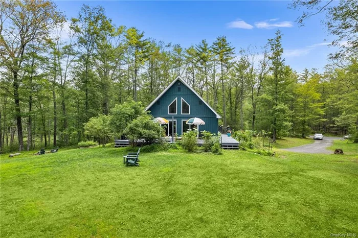 Experience serene mountain living in this contemporary chalet nestled on an expansive 8-acre lot in West Hurley, NY. Embrace tranquility with panoramic views and a wrap-around deck perfect for relaxing or entertaining. This unique home offers two bedrooms and 1.5 baths on the main level as well as a spacious primary en-suite with a full bathroom on its own level for ultimate privacy. Enjoy the convenience of a main-level laundry room and ample storage throughout. Ideal for those seeking a blend of modern comfort and natural beauty, this property promises a lifestyle of peace and serenity amid picturesque surroundings. Conveniently located within a short 15 min drive to artistic Woodstock and historic Kingston areas.