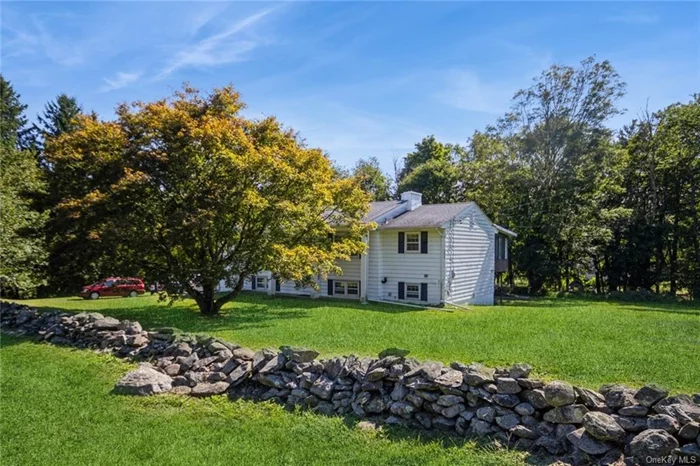 Check out this Colonial-style Raised Ranch with pillared front nestled on lovely tree-lined surroundings on almost an acre. This home offers a very unique and spacious floor plan that flows effortlessly featuring plenty of space for large gatherings. On the main level you&rsquo;ll find an enormous living room with a wood burning fireplace, a large eat-in kitchen with breakfast area and generous sunroom with loads of windows, high ceilings and pellet stove. This is an ideal space for both entertaining and relaxing. There are also 3 bedrooms and 1.5 baths on this level. The lower level has a sizable family room with SGD and fireplace with woodstove insert, den, 2nd living room/kitchenette area, storage room, full bathroom and utility room (hot water not working kit/bath - as is). This home is perfect for mother/daughter. Another highlight of this property is its private, level backyard with a trek patio and firepit area. This outdoor space provides a wonderful opportunity for gardening, outdoor dining, or simply enjoying the beautiful surroundings. Located in close proximity to major highways, shopping, and dining - making it an ideal place for those who appreciate a balance between city conveniences and country living.