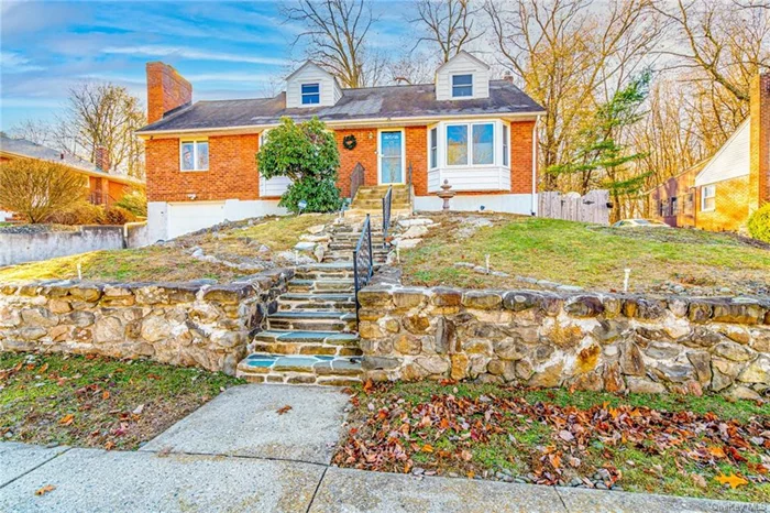 Charming 4-bedroom Cape on a quiet, tree-lined street. The sunlit living room features hardwood floors and quad-bay windows. The first-floor master bedroom also has quad-bay windows and a side window. A second first-floor bedroom and remodeled full bath are nearby. Enjoy forest views from the dining room, and French doors lead to a spacious family room with a fireplace and double glass doors opening to a 40&rsquo; x 15&rsquo; deck, perfect for gatherings. The kitchen, with stainless steel appliances, has access to the deck. The second floor includes 2 bedrooms and a bonus room. The basement features a separate entrance, finished den, half bath, laundry, and ample storage with potential for extra living space. An attached garage and driveway fit 5 cars. Convenient location near Beacon Metro-North, waterfront, Stewart Airport, NFA, West Point, and more. Featured on House Hunters S. 238, Episode 7!