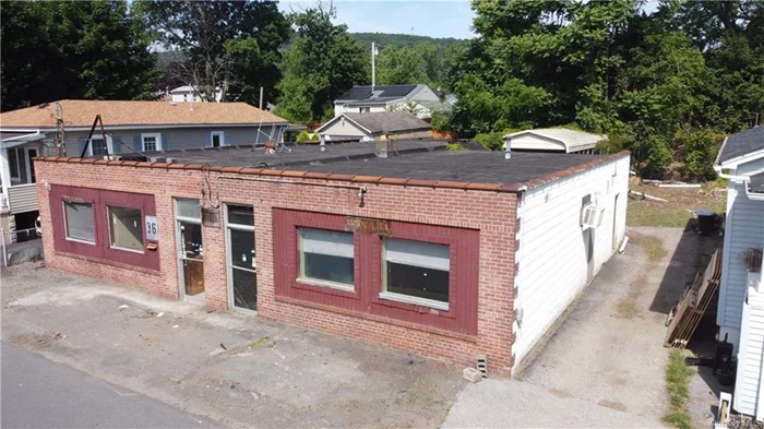 This one level commercial building is located in a quiet residential neighborhood, perfect for a quiet commercial enterprise.  Subject consists of a total gross building area of 3, 348 square feet consisting of 1, 348 square feet of finished office space and 1, 992 square feet of rough finished workshop/light industrial space with two lavatories.  Offices are currently combined into a single office with a pass-thru between the two parts of the structure. Two separate front retail-style windows, a large loading dock style door at grade, three side exits.  Former printing press operation. Located within R4 zoning, property&rsquo;s commercial use for office/workshop is grandfathered in.  Any other commercial use would need a variance. Property is being sold as-is along with existing fixtures and machinery. Sold as-is. Buyer to pay NYS and any local transfer taxes. Offers with financing must be accompanied by pre-qual letter; cash offers with proof of funds.