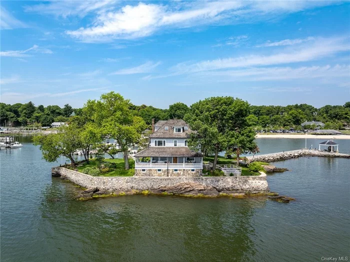 A one-of-a-kind offering, this property provides sweeping views of Long Island Sound and the allure of your own island. The expansive half-acre property, shaded by mature trees, also features its own boat dock and two boats for exploration of nearby waters and islands. Meticulously landscaped grounds with beautiful perennial gardens provide a picturesque setting for outdoor events. A quaint stone pathway leads to a gazebo equipped with a fireplace, ideal for outdoor dining, cocktail parties, or quiet reading sessions. For water sports enthusiasts, the property provides a kayak and paddle board rack along with a launch area. The residence boasts a wide wrap-around porch offering unmatched views and a lower deck designed for relaxation. The living room, serving as the centerpiece of the  home, showcases panoramic views of the Sound and is centered around an exquisite stone fireplace. Opening onto the covered porch, residents are encouraged to enjoy the coastal scenery both indoors and out. The dining room also offers impressive water views, while the spacious eat-in kitchen is outfitted with granite countertops, Subzero and Wolf appliances, and features views of the garden and harbor. The primary bedroom offers stunning views of Long Island Sound, complemented by two additional double bedrooms with water views, and another double bedroom offering delightful views of the harbor. The third floor provides flexibility to accommodate two more bedrooms or personalized spaces. An office with harbor views completes this welcoming home. Marrying quintessential coastal New England living with convenient proximity to NYC, this property offers a once-in-a-lifetime opportunity for a discerning buyer.