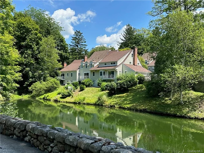 YEARLY RENTAL. Two bedroom, two and a half bath townhouse located at Millbrook Hollow in the heart of the village. Stone walls line the entrance and roadways, and a pond provides a beautiful landscape surrounding this unit. The spacious first floor has an open flowing layout with wood floors. There is an updated kitchen with a pass through to the dining area. The living room features a cozy fireplace, built-ins and sliding glass doors accessing the deck that overlooks the pond. The second floor has two ensuite bedrooms and a third floor offers a bonus room with built-in shelving. The lower level has a two-car garage, storage, laundry area with washer and dryer, an additional refrigerator, and accesses the patio overlooking the pond. A wonderful opportunity to rent in Millbook Hollow surrounded landscaped grounds and within the village of Millbrook.