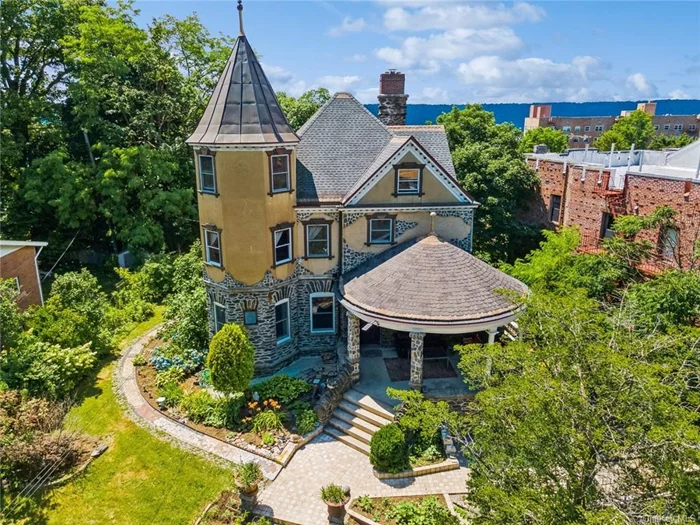 Captivating 2-Family Victorian Home in Historic Park Hill, Yonkers. The Seller will only consider offers in the range of 920k-990k. This is your chance to live in a castle! Step into a world of timeless elegance and modern comforts with this stunning Victorian home, built in 1885. Nestled in the historic neighborhood of Park Hill, Yonkers, this residence boasts 7 bedrooms, 3.5 baths, and over 5, 027 sq ft of living space, including a partially finished basement, offering a perfect blend of classic charm and contemporary convenience. This property is currently being used as a mother/daughter house, providing exceptional flexibility and the potential for additional rental income. This home is a testament to exquisite craftsmanship, featuring intricate woodwork, stained glass windows, and original details throughout. Cozy up by the fireplaces and enjoy the grand foyer featuring original woodwork and a stunning staircase. The kitchen is equipped with modern appliances, blending contemporary and classic design elements seamlessly. Each bedroom is spacious and filled with natural light, providing a peaceful retreat for family members and guests. The living and dining rooms, with high ceilings, large windows, and elegant decor, are perfect for entertaining. The large open porch is perfect for enjoying morning coffee or evening relaxation, surrounded by the beauty of the garden. The 0.18-acre lot provides ample space for outdoor activities and gatherings, including a 2-car garage, ample storage space, and a lovely patio area. Historic Park Hill in Yonkers is known for its charming, tree-lined streets and historic homes, offering a serene and picturesque setting. The property is within walking distance of the Metro-North station and downtown Yonkers waterfront, providing easy access to transportation, shopping, and dining. Enjoy nearby parks and recreational areas, perfect for outdoor activities and family outings. Don&rsquo;t miss the opportunity to own a piece of history with all the modern comforts you desire. Schedule a private tour today and experience the magic of this unique Victorian home.