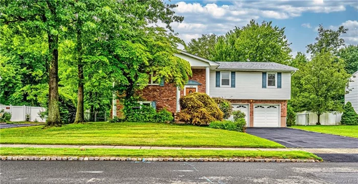 PRICE REDUCED Offered after 30+ years of residency in the most desirable location of Nanuet...this bright and lovely raised ranch home awaits you. Entry foyer will welcome you to a spacious living room with large window opening up to the dining room. Eat-In Kitchen with skylight, island, and sliding glass door leading to a nice deck. Main floor also highlights full bathroom, 2 bedrooms, primary bedroom w/ walk-in closet and primary bathroom. Ground level showcases a brick fireplace and built-in shelves w/direct access to patio/backyard, half bath, 4th bedroom, laundry, utility room, and access to 2-car garage. Hardwood floors throughout. Many updates throughout house is about 10 years old. HVAC is about 5 years old. Roof is about 4 years old. Yard is great for entertaining. Great and convenient location to all. Suburban Living at its BEST.