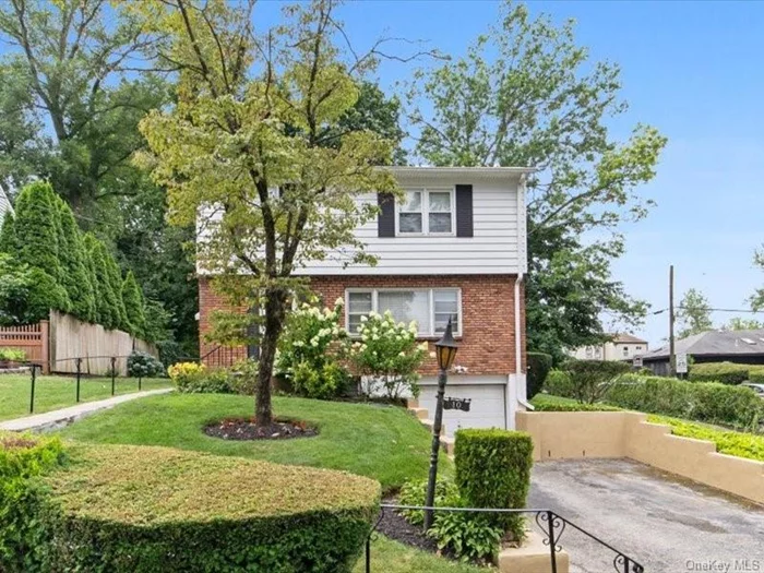 Welcome to 10 Benedict Ave, located in the heart of the Leewood section of Eastchester! Easy 5-minute walk to Crestwood Train station,  35-minute express Metro-North train ride to Grand Central Station, NYC. Enjoy this bright, spacious 3-bedroom corner colonial with fresh new landscaping/sprinkler system. This house offers plenty of closets & beautiful original hardwood floors. Upon the walk-in entry, the 1st floor offers a true entertaining flow between the large sized picture window living room, eat in kitchen and dining room with sliding doors to your patio /back yard and a half bath. Upper level offers 3 bedrooms, spacious upper hallway to generous sized full hall bath. Walk out lower level offers finished storage room, separate utilities area, ample parking space in the driveway for 4-6 cars and a 1 car attached air-conditioned garage. Recent Generator and new electrical wiring for Generator are included in this sale. Owners can enjoy a Lake Isle country club membership, available for an additional summer package offering 5 pools, tennis/pickleball, golf & golf pro shop, snack bar, etc.. Eastchester School bus pick up on the corner of Benedict & Oakland.