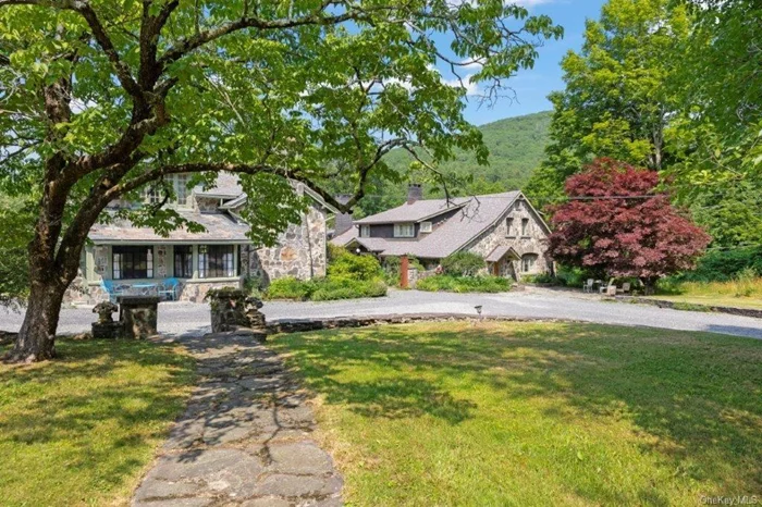 Happy Brooks, the Graceland of 1960&rsquo;s counter culture, is waiting for you!  Home to Woodstock Festival co-founder and legendary music industry icon Michael Lang for 45 years, this Mt. Tremper compound boasts a pedigree that dates back to the 1920s. Originally built for the artist G. Adolph Anderson, the 17 acre estate features three architecturally significant & historic structures; The spacious main house, stylish guest house and sweet cottage are all made from stone and imagination, with the original home designed by prominent architect A.M. Bedell in 1929 and the additional residential buildings following in 1933.  Entering the primary residence is to step into history. The stunning double-height great room with balcony has played host to renowned artists of every stripe through the decades, with the inspired design detail easily matched by the art and music created within its walls. In this wing you will find an office, two powder rooms & upper level bedroom and library. Just past a massive bluestone fireplace, a central foyer leads into a formal dining room with mountain views, a country cooks kitchen, breakfast area and an open-plan family room with another massive fireplace with wood stove & built-in bread oven with more verdant views across the cool grass and pergola-covered patio just outside French doors. Strolling the grand light-filled hallway will take you to 3 oversized bedroom suites, including the romantic primary, as well as a reading room found behind magnificent stained glass doors with 3 walls of window seats overlooking the lawn below. Connecting this wing of the home is a spectacular conservatory within a 24-foot glass ceiling, the perfect place to cultivate plants, paint a masterpiece or simply dream big.  Across the central courtyard framed by a wide, mature birch tree is a two bedroom guesthouse that holds pure design treasure. An oversized living room flooded with light leads into a den with a special bluestone fireplace and a striking built-in collection of Fu dogs and wood-carvings on gilded plaques collected from travels to China that depict an epic story. There is also a charming dining area and full kitchen.  The third stone structure is a two bedroom fully-outfitted cottage that has been stylishly updated, and is connected to a three-bay garage and a greenhouse ready to be either restored or turned into a Romanesque walled garden. Additional structures include a tool shed and three-stall barn, as well as an enchanting picnic pavilion sited up on a knoll with views of Slide Mountain, the tallest peak of the Catskills.  The estate is truly park-like, with paths, stone walls, orchards, fields of wildflowers and a centerpiece large pond with its own art island that showcases a sculpture by Michael Lang. For hot summer days you can enjoy a swim in the 53 x 40 oval lined cement pool while gazing at the mountains in the distance. Mt.Tremper has long been a special community located just minutes from both Woodstock and Phoenicia, so an afternoon spent tubing the Esopus or an evening at the revitalized Bearsville Theatre is almost as easy as the thought itself.  Happy Brooks, only two hours from NYC is ready for its next dedicated steward, and is the perfect place to gather, or to just relax and soak up the history that flows from every bit of this legendary estate.  Your country dream come true!