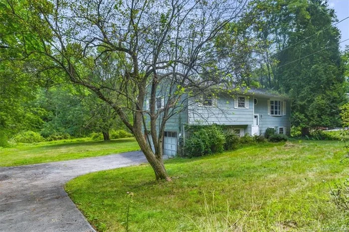 Nestled in the serene town of Hamptonburgh, this charming bilevel home exudes vintage charm while offering ample opportunity to infuse your personal style. Located on a beautiful lot set off a picturesque country road, this home provides a perfect balance of privacy and convenience. Step inside and be greeted by the warm, inviting atmosphere that only a vintage home can offer. The main level features a spacious living room bathed in natural light and a cozy dining area perfect for family gatherings. Original hardwood floors add to the home&rsquo;s timeless appeal. The upper level hosts three generous bedrooms, each with its own character and charm. The vintage-tiled bathroom provides a delightful nod to the past while offering the comforts of today. The lower level boasts a versatile space that can be tailored to your needs  whether it be a family room, home office, or additional guest quarters. A half bath and a laundry area add to the functionality of this floor. Outside, the expansive yard offers endless possibilities for relaxation and recreation. Mature trees provide a sense of tranquility, and the open space is perfect for gardening, outdoor entertaining, or simply enjoying the beauty of nature. Despite its peaceful setting, this home is just a short drive to the quaint shops, charming eateries, and community events in the surrounding areas. Plus, with New York City approximately 60 miles away, you can enjoy the best of both worlds  a serene country lifestyle with the excitement of the city just a train ride away. Experience the unique charm of this vintage bilevel home and make it your own. Private but not secluded, it&rsquo;s the perfect place to create lasting memories. Don&rsquo;t miss this rare opportunity to own a piece of Hamptonburgh&rsquo;s history!