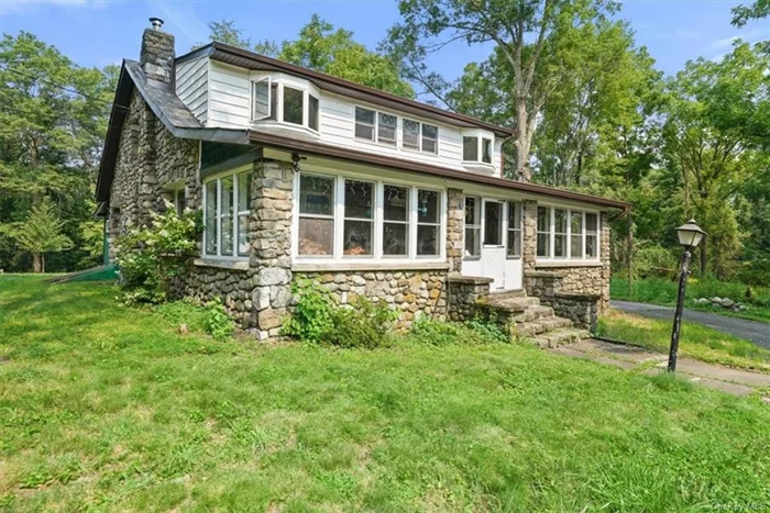 Welcome to this one-of-a-kind, 3-bedroom, 2-bath stone cottage, beautifully set on 1.8 acres of picturesque land. Imagine unwinding on the enclosed porch, surrounded by the serene beauty of nature. This home boasts stunning hardwood floors and exposed beams throughout, exuding rustic charm. The abundant natural light adds warmth to every room. Upon entering, you&rsquo;re welcomed by a spacious living room, complete with a cozy wood-burning stove perfect for chilly evenings. The adjacent dining room offers a wonderful space for gatherings and a full bath on this level adds convenience. The large eat-in kitchen is a chef&rsquo;s delight, featuring a stainless-steel refrigerator, granite countertops, a central island, and custom-built cabinets that provide ample storage. Ascend to the upper level to find a charming sitting room, ideal for relaxation or a quiet reading nook. The primary bedroom is a true retreat, with private access to a full bath that includes a whirlpool tub and a cedar shower. Two additional generously sized bedrooms offer comfort and space. Outside, a large circular driveway and a 2-car heated garage add to the home&rsquo;s functionality and convenience. Recent updates include new gutters, French drains, new insulation and a vapor barrier in the crawl space, a new liner for the chimney, a new oil tank, and a new washer. Beautiful wood floors under the carpet upstairs. This home effortlessly combines comfort, craftsmanship, and modern functionality, making it the perfect sanctuary. Experience the best of the Hudson Valley and the Village of Washingtonville, with easy access to shopping, restaurants, hiking and biking trails, wineries, breweries, farms, golf courses, state parks, and the excitement of Legoland.