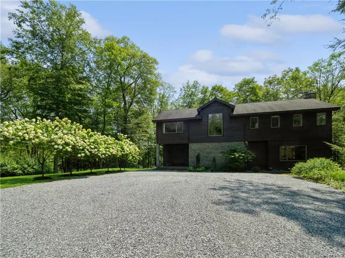 This contemporary home in Garrison offers a tranquil retreat in the picturesque Hudson Valley. A long, scenic driveway sets the tone for the serene and private setting, yet it is minutes from the Village of Cold Spring and trains. The house is thoughtfully designed with expansive windows that create a seamless connection with the natural surroundings. The chef&rsquo;s kitchen, perfect for culinary enthusiasts, opens to a screened-in porch, blending indoor and outdoor living spaces. The kitchen flows into an open living area featuring a cozy wood fireplace. The main floor also includes two versatile office/den spaces and a full bathroom. Upstairs, the home boasts three spacious bedrooms and three full baths. The primary suite is complete with blue travertine finishes, a steam shower, and a separate bathing room. Your new recreation room provides endless possibilities for additional living/entertainment space. For the eco-conscious, there is an electric car outlet. Easy access to hiking trails.