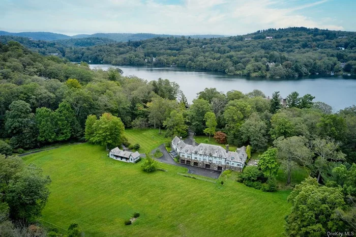 The only equestrian home located in the beautiful village of Tuxedo Park - Iconic Blue Stable. Tucked along a quiet winding road is this idyllic 11-acre horse farm anchored by a classic 5, 000+ square foot stone carriage house and stable originally built in 1910 and lovingly restored by the current owner, complemented by a second stable structure and several outbuildings. Located within one hour of NYC, this property is ideal for horse lovers. and offers a rare opportunity to live in a historic equestrian estate just 35 miles from New York City. With no details spared, this stone manor boasts 5 bedrooms, 8 (6/2) bathrooms, a large cathedral-ceilinged dining room and renovated barn-beam chef&rsquo;s kitchen, Viking twin refrigerators, large 6 burner stove, hammered metal farm sink. Blue Stable&rsquo;s elegance combines both formal rooms along with comfortable family spaces and 3 fireplaces. The large patio off the back of the house provides a wonderful area for entertaining. The upper stable houses a converted entertainment/pool table room in between two stables. There are approved plans for a large pool. This gated property has old growth trees, professionally curated botanical plantings plus vegetable and flower gardens. An old barn sits on a hill overlooking a former riding ring. A stone root/wine cellar and lower stable complete the charm of this unique property. This property was formerly owned by Olympic Dressage gold medalist John Winnett. The stable property features room for 2-3 horses, Nelson horse waterers and Evopave interlocking rubber floors. The 3 outdoor horse waterers are attached to a well. There is a generous tack room in the main house and also in the stable. In the summer kitchen at the stable is a washer/dryer hookup for blankets. Electric is run for indoor horse waterers along with a trophy and ribbon room.