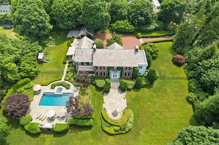 Unparalleled elegance in this 6-bedroom brick Georgian Colonial, reminiscent of an English estate on rare 1.5 private & picturesque property. A long private drive bordered by flowering shrubs, beautiful circular entrance w/ artistically landscaped medallion. Unique front-to-back reception rooms, center hall layout, high ceilings throughout. Magnificent inground pool & hot tub surrounded by gracious terrace, putting green/sand trap, tennis backboard/basketball court. Sq ftge includes 875 legal sq ft in basement. With its prime location, residents enjoy easy access to the station and a short stroll to the quaint village of Rye with its charming shops and restaurants. Experience the epitome of luxury living in this exquisite Georgian Colonial, where every detail is designed for comfort and sophistication. Inclusions galore and Furniture can also be purchased.