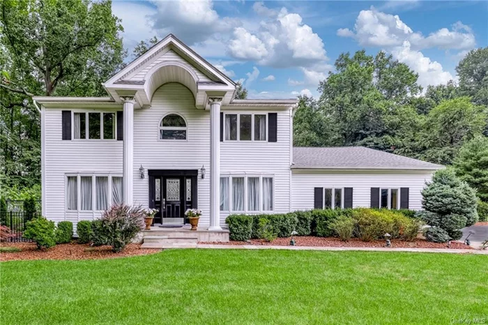 Seeking perfection? Discover it in this flawless Center Hall Colonial where form, function, and beauty converge. Set in the coveted neighborhood of North New City, this home boasts enchanting curb appeal and sits on a private, level acre that borders scenic Zukor parkland. Recently updated with the finest materials and craftsmanship, it features a Therma-Tru front door, Andersen and Pella casement windows, crown molding, and recessed lighting. The sparkling white kitchen with granite counters and a Sub-Zero fridge is complemented by bay windows that flood the space with natural light and overlook the lush yard. Enjoy a full-wall brick fireplace with a floating mantel, gleaming hardwood floors, solid oak railings, and high-end custom baths adorned with Versace tile. The master suite includes a tray ceiling, ensuite bath and walk-in closet, while the hallway features a tunneled skylight. Additional highlights include a stone walkway, electric awning, double-tier deck, new roof and garage door, sprinkler system, and indoor/outdoor speakers. With top-rated Clarkstown Schools, shopping, and transportation nearby, this home redefines the notion of perfection.