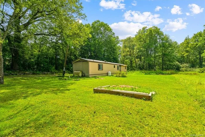 This 3-bedroom, 2-bathroom manufactured home is situated at the end of a quiet cul-de-sac with over half an acre of land in the Washingtonville School District. This home features an open concept living room, kitchen, and dining room with vaulted ceilings, creating a spacious and inviting atmosphere. The large master bedroom boasts an en-suite bathroom, and all bedrooms come with spacious closets. The kitchen includes a peninsula bar countertop, perfect for a breakfast nook. Enjoy outdoor living & nature with lots of space and privacy. The driveway parking can fit over 8 vehicles, and the expansive yard offers endless possibilities. With low taxes and an attractive price point, this affordable property is brimming with potential and will not last.