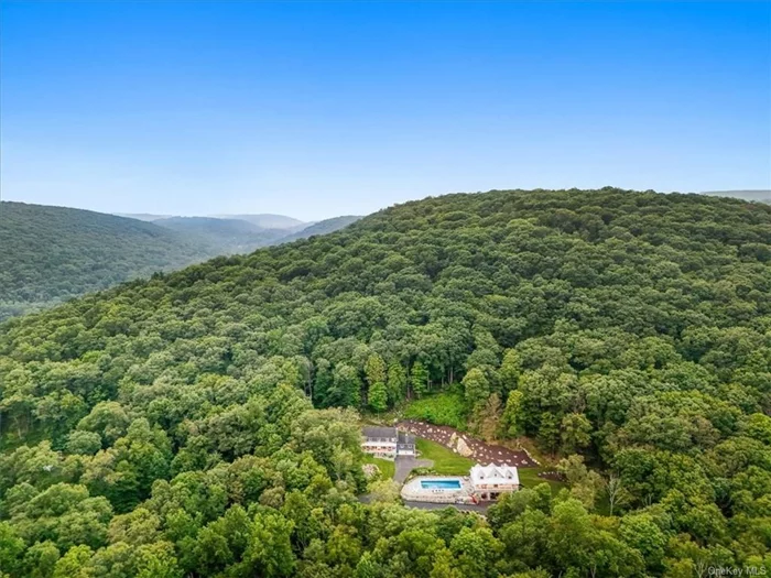 Situated on two lots for a total of 15.5 acres, offering an abundance of privacy is only the beginning of what you will find as you enter the grounds. Welcome to 25 Red Oak Lane, an hour from Manhattan you will begin your tour with a Colonial home. This main house built in 1990, features 4 bedrooms, 2.5 baths and updates during 2018-2021. Begin at the front walkway and find an expansive front porch adding a modern finish with cable railings. Enter and find yourself enamored by its beautiful wide plank hardwood floors. Discover a great room with fireplace, living room, powder room, family room with bar, wood burning stove, loft, and cathedral ceilings. Crown moldings, built ins, and plenty of natural light adds warmth and luxury to this home. Enjoy entertaining your next holiday in this house intended for guests in a kitchen designed with a massive island in granite, custom cabinetry and a tray ceiling. Delight your family with creative food dishes out of an authentic wood burning pizza oven. Second floor finds a primary bedroom with a bay window, walk-in closet, renovated primary bathroom 2021, retractable tv, hallway bathroom and 3 bedrooms. Basement level includes gym, game room, home office, plenty of storage and garage parking for 2 cars. Enjoy having a custom designed shed completed in 2018 for a storage of wood piles. Pool house built in 2021 is perfect for guest&rsquo;s visits. This modern farmhouse with a wraparound deck features a loft bedroom and 1.5 baths. Its open floor plan allows a full kitchen, dining area, living room area, wood and gas fireplace, and built ins. Look up and find yourself mesmerized with its iron gable catwalk, alluring reclaimed barnwood ceiling and custom-made prism chandelier. Enjoy a 22x50 inground pool and jacuzzi. This house was also built for the car enthusiast. Its luxury garage is with air conditioning, radiant heating floors and 4 bays with glass windows large enough to park an RV or boat, and mechanical lifts allow space for a total of 7 vehicles. Not a hobbyist for cars? Then transform this space into an indoor basketball court, or add a golf simulator, wine room, and more to this lower level of home. Put your unique touch in this space and make it your own personal playground. Enjoy all that nature has to offer here with grounds that boast a stream, groomed trails for hiking, garden house to pick your own vegetables, and collect your own honey from a bee house. Make countless memories in what can be your forever home or your own fabulous vacation house!