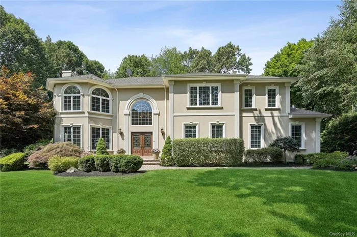 Tucked neatly away at the far end of a private drive, this exquisite Modern Transitional Colonial sits gracefully on .57 plush acres in Pearl River. Custom built boasting a stately stucco exterior with turret-style architecture, this pristine 5BR, 3BA property hosts nearly 3800 square feet of living space. Warm, inviting, and spacious, the home is awash in natural light. It courses through the open-concept interior, pouring in from all directions through massive windows that transcend floors and stretch high toward the ceiling, some reaching 18 feet in the impressive great room. Timeless built-ins, with a keen emphasis on craftsmanship, flank the fireplace and two sets of french doors open to the back paver patio with lounging, dining and bar areas, surrounded with tall lush greenery.  A vast gourmet kitchen with counter seating for five comes with restaurant-quality Viking and SubZero appliances. The primary suite flaunts trey ceilings, a sitting room with infrared sauna, luxury bath and French doors that open onto an exterior balcony for relaxing moments. The first-floor bedroom and full bath are perfect for guests or extended family. There is radiant heat flooring throughout. Professionally landscaped with irrigation, the yard with rolling lawn & dollhouse shed, are well maintained, ready for fun. Ideally located in the highly rated Pearl River School District, just down the road to Lincoln Elementary. Easy access to all the wonders of the Hudson Valley, this hidden treasure awaits discovery.