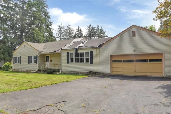 This home is not quite ready for you to start moving in your furnishings, but it is totally ready to start moving in your electrical, plumbing, HVAC and carpentry tools. This ranch style home is located on a dead end street in a pretty and less traveled neighborhood in the Village of Ellenville. The home has three bedrooms, one bath, hardwood floors, sliders to a rear patio, and an attached two car garage. The place will need significant repairs to bring it back, so any financing will likely need to be rehab financing. The home has great potential, so book a showing today.