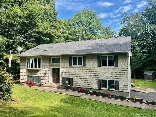 This beautiful home is located in the Historic Town of Putnam Valley with Mahopac Schools only 2 miles from the Taconic Parkway. Sitting majestically near the end of the culdesac on a a lush 1.25 acres of property, it boasts an upstairs including 3 bedrooms (one primary ensuite with walk in closet) an additional full hall bath, exquisitely renovated eat in kitchen with lighted granite counters tops and stainless steel appliances and a sliding glass door to the deck overlooking your private oasis. The living room has cathedral ceilings with 2 skylights that extend to the generously sized Formal Dining Room. Downstairs offers a wonderfully finished basement, above ground, that is bright and inviting and completely ready for extended family to stay or a home office. It includes a large eat in summer kitchen, full bath, office with closet and sliding glass doors to the level back yard. Recent upgrade are full Generac generator system as well as rubber floor to the garage, fresh paint and much more !! A perfect combination of house and location. Make your appointment today !!