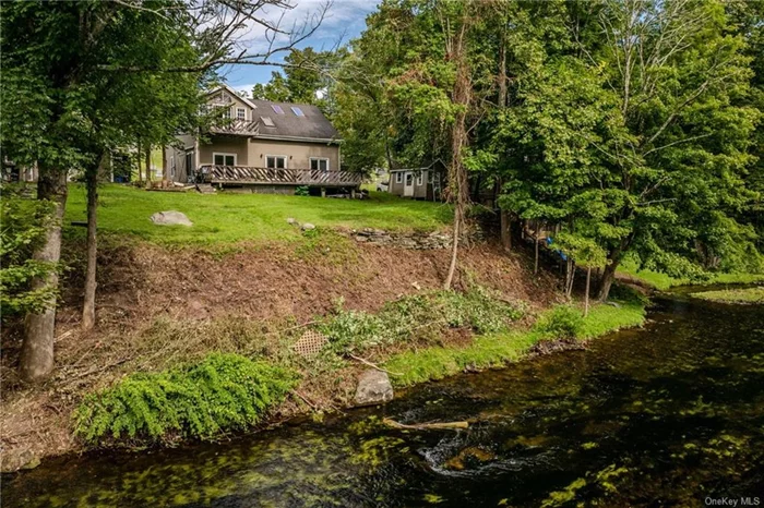 Imagine waking up to the gentle sound of the Neversink River flowing just beyond your window, a reminder that you&rsquo;ve found your sanctuary in the heart of the Catskills. This is more than just a home it&rsquo;s a living story, where every beam and brick tells a tale of history, craftsmanship, and the joy of nature&rsquo;s embrace. Once an 1800s hay barn, this stunning property was lovingly relocated in 1926 and has since been transformed into a haven that marries the past with the present. As you step inside, the sun pours through five skylights, illuminating the open floor plan. You can almost hear the echoes of its past as a carriage house, wood workshop, and photo studio, all while imagining the future memories you&rsquo;ll create here. The original hand-hewn beams stretch across the cathedral ceilings, a testament to the artisans who built them. In the gourmet kitchen, with its stainless steel appliances and granite countertops, you can almost smell the aromas of meals shared with loved ones. The gas fireplace in the dining area flickers softly, creating a warm, inviting space that feels like home the moment you step inside. Upstairs, the master suite becomes your personal retreat. With a serene sitting area, additional room for storage, and a private deck overlooking the expansive backyard and the river beyond, it&rsquo;s easy to picture quiet mornings with a cup of coffee or peaceful evenings watching the sunset. The additional bedroom on the first floor offers flexibility, whether it becomes a guest room, office, or space for hobbies. Step outside onto the large back deck, where the Neversink River becomes an extension of your backyard. Whether you&rsquo;re fishing, kayaking, or simply soaking in the natural beauty, this is where you&rsquo;ll find peace and inspiration. This riverfront sanctuary is more than just a place to live it&rsquo;s a place to thrive. Located just a short walk from the charm of town amenities and only 90 miles from the pulse of New York City, you&rsquo;re perfectly situated to enjoy the best of both worlds. For those looking to expand their investment, an additional income-producing property next door, with three separate apartments, is also available. This is your chance to own a piece of Catskills history, to become a part of the story that this home continues to tell. Don&rsquo;t miss out on this poetic retreat schedule your viewing today and start writing the next chapter of your life here.