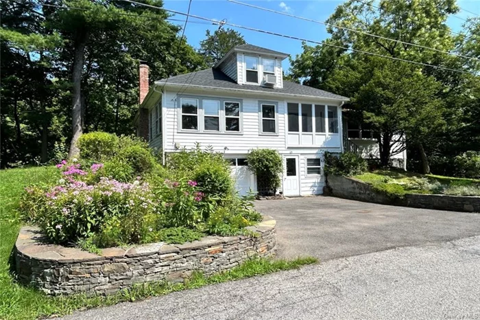 Situated in the riverside hamlet of Rhinecliff, this two bedroom c1940 bungalow retains many original elements. Beautiful hardwood floors, beamed ceilings, wood trim, and ample light delight throughout. The first floor consists of the kitchen, living room, bedroom, full bath and a large room with a wood stove. Upstairs the second floor is one large studio space currently serving as the second bedroom. At ground level find a generously-sized garage with laundry. A private back deck accessed via French doors from one of the main living rooms, overlooks a small pond and mature landscaping. New roof and furnace. Partial river view expands with the seasons. Walking distance to the Amtrak station, the Rhinecliff dock and boat launch, and only a three minute drive to the center of Rhinebeck Village.