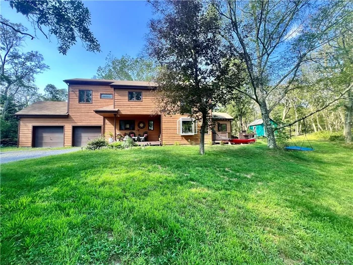 This rustic contemporary home nestled on 2.87 acres of wooded property that gives you lots of privacy just 5 minutes to the Taconic Parkway and an easy commute to Metro North trains. Step in thru the front door to a living room with 18ft ceilings, a unique brick floor, a garden window, and a pellet stove for heating. and doors leading to a side deck. Step up to the dining room that showcases a wood beamed ceiling and is open to the Eat-in-Kitchen with an island & stainless steel appliances. Access from the kitchen to a spacious two car garage also with high ceilings. There is a master bedroom on the 1st floor with dual entry and a laundry/utility room. Upper level features: a large bright bedroom with vaulted ceilings and the 3rd bedroom with a built in ladder to a cool loft. Newly renovated bathroom and space for a home office. Conveniently located near many attractions within 10-20 minutes. The home is in the Arlington School District. This unique home welcomes your family!