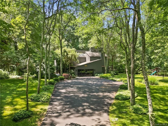 Tucked away from the road, this modern tranquil four-bedroom home offers a private retreat on nearly 3 acres of lush, flat land. The open-concept main floor features a spacious living room and dining area that flow seamlessly into an eat-in kitchen with a large sliding door leading to your deck. Adjacent to this is the cozy family area with a wood-burning fireplace and built-in entertainment center.  Upstairs, unwind in your primary bedroom suite, complete with a walk-in closet, luxurious bathroom, and a sunlit porch. The second floor also includes three additional bedrooms with vaulted ceilings and skylights, plus an extra bathroom. Light abounds for the glorious landscape to change with the seasons.   With a 2-car attached garage, mudroom, laundry room, and a generous storage area in the basement, this home meets all your practical needs. Enjoy the tranquility of the William Love Preserve right next door, while still being conveniently close to Oakridge Commons, Scotts Corners, and just 10 minutes from the New Canaan Metro North. 720+ credit score for every adult.