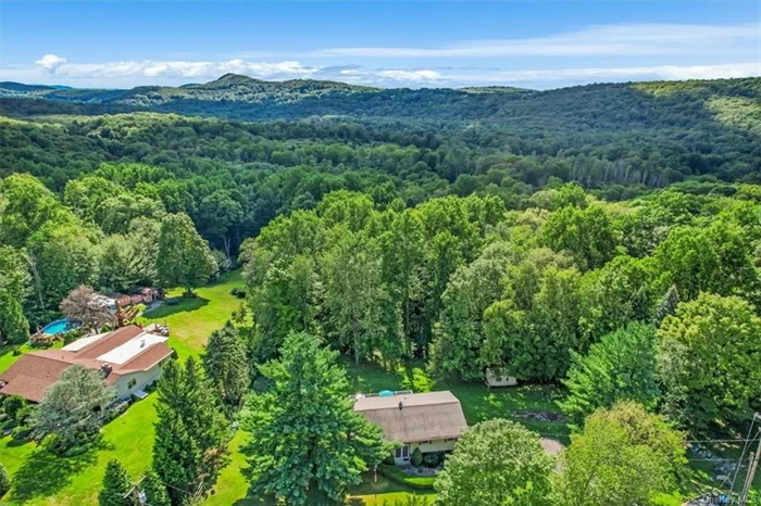 Charm & Sunshine await you in this bi-level home. Pride of ownership is obvious and has been meticulously maintained. The living room provides a cozy and inviting space for entertaining guests. For those who enjoy dining in style, the formal dining room opens up to a spacious deck, offering a wonderful setting for outdoor enjoyment during warm weather. The deck overlooks 1+ acres of park like property which backs up to Goose Pond Mountain State Park. The kitchen makes every square inch count with an efficient design and Corian counter tops. There are hardwood floors throughout the main level. Comfort and tranquil characterize the primary bedroom offering an updated primary bathroom. The two additional bedrooms on this floor are light, bright and roomy and share a hall bathroom. The built to take it lower level family room with fireplace has a slider leading out to the patio and the backyard. A half bath and laundry room complete the lower level. The home has been freshly painted.