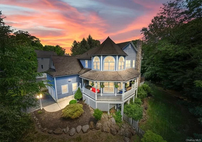 Discover tranquility in this welcoming young Victorian-style gem, boasting over 3, 000 square feet of exquisite living space. Nestled with a charming white picket fence in the rivertown of Piermont, NY, this home features a picturesque wrap-around porch and offers breathtaking seasonal views of the Hudson River. Immerse yourself in luxury and charm in one of the area&rsquo;s most sought-after locations. As you enter, you are greeted by high ceilings and a thoughtfully designed floor plan that first showcases the formal living room. This elegant space features walls of windows, cherry inlay hardwood floors, and custom built-in bookcases and cabinets. Adjacent to the living room, the dining room boasts sliders that open onto a charming porch. At the back of the house, you&rsquo;ll find a cozy family room adorned with a stone fireplace and a large picture window that seamlessly blends the indoors with the outdoors. French doors lead to a deck, creating an inviting space for relaxation. The outdoor area is simply breathtaking, featuring a sprawling, hilly yard with spectacular natural views. The heart of the home, the kitchen, features a butcher block island, custom cabinets, and a wall of windows that flood the eating area with natural light. This main level also includes a private powder room and a convenient laundry/mud room that leads to a two-car garage with soaring ceilings. The upper level features four spacious bedrooms and an additional versatile flex room. The extraordinary primary suite invites you to wake up to breathtaking views through a large picture window, filling the room in natural morning sunlight. The expansive ensuite bathroom, designed in crisp white, includes a double sink vanity, a soaking tub, and a walk-in shower. Completing the suite is a walk-in closet outfitted with custom built-ins for optimal organization. The front southern bedroom boasts cathedral ceilings and a wall of windows, creating a bright and airy feel. The northern bedroom provides access to an additional room, perfect for a flexible space to suit your personal needs. The unfinished lower level of this home presents a versatile space ready for your vision. With extremely high ceilings, daylight windows, and sliders leading to the side yard, the possibilities for finishing are endless! This wonderful home is just moments from the Hudson River and all the attractions of Piermont, including shops and eateries. It&rsquo;s also in close proximity to the Village of Nyack, the New Jersey border, and major routes for convenient commuting.