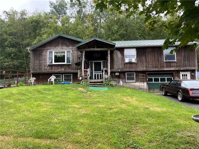 Home with redwood siding ++ 50&rsquo; x 40&rsquo; steel building with one lift ++ 3 stall barn and hay loft on almost 6 private acres with fenced paddocks. Private farm setting, former animal sanctuary, lined with trees and long frontage off quiet town road is ready for a new owner. Plus steel building offers an enormous workspace. Electric heat in home supplemented by owned solar panels. Small sheds not included with sale of property.