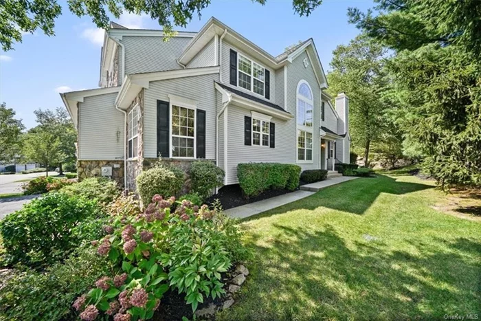 Truly exceptional, immaculate end-unit townhome in ever desirable The Woodlands at Tuxedo, where privacy, comfort and elegant lifestyle come together.  The front walkway is flanked by gorgeous pines and specimen plantings and leads to a classic colonial entry. Inside, the Cambridge offers an expansive open concept entry w/ 2-story soaring dining room with palladian capped windows. Adjacent is the living room with wood burning fireplace, and on the other flank the beautiful eat in kitchen. The entire home is light-filled, airy and has a comfortable flow. The stylish kitchen with dark stone counter-tops and designer cabinetry, elegantly punctuates this luxury living opportunity.  The first floor primary suite is a haven of comfort and privacy; with a vaulted ceiling, a generous walk-in closet and a stunningly remodeled bathroom in contemporary accent makes this primary suite a relaxation retreat. The upstairs offers an additional bedroom and a flex room for office, a hall bath and a sitting room overlooking the gorgeous lower level. Newer hardwood floors as seen. Outside is a lovely back patio, level lawn and adjacent stone wall with forest behind; here for entertaining, barbecuing and fresh air in all seasons. The full, unfinished basement is ripe for additional creative uses. A 2-car garage with new floor finish, and 2-car driveway parking rounds out this special home. The Woodlands at Tuxedo is approximately 1 hr to Manhattan, and inside 15 minutes to Bergen County, NJ, and yet you feel a world away. This well-established HOA community boasts outdoor tennis and swimming pool as well as a charming community clubhouse with exercise room and common areas. The community is adjacent to a town park for recreation, and nearby to Sterling Forest, with over 20, 000 acres of forever preserved state forest and miles of nature trails.