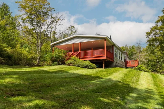 Nestled amidst the breathtaking scenery of Jewett, NY, in the northern Catskills, this cozy, light-filled home is move-in ready and awaits your personal touch. Built in 2009 this delightful 3-bedroom, 2-bathroom manufactured home is set on 7.4 acres along a tranquil road. Easy one floor living, reasonable to heat, cool, and maintain so you can embrace the leisurely summer days on the expansive back deck and revel in the comfort of a warm, inviting fireplace during the winter months. The location of this property is truly exceptional, offering a plethora of outdoor activities throughout every season, such as skiing, golfing, hiking, zip lining, and gorgeous lakes, providing endless opportunities for adventure. Delight in the exquisite culinary offerings of nearby restaurants and vineyards, and partake in the vibrant local festivals, all conveniently just minutes away. Updates include new roof last year.