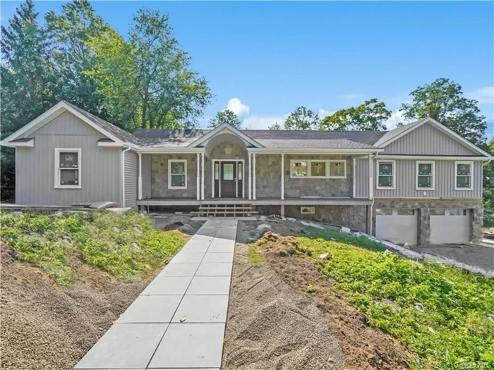 This fully renovated gem offers the perfect blend of modern luxury & serene living on a private.73-acre lot. Step inside to discover an expansive open-concept main level, highlighted by cathedral ceilings. The cozy living room features a fireplace w/mantle & French door to oversized composite deck. The sun filled, custom kitchen seamlessly flows into the dining room with double sliding glass doors deck, ideal for outdoor dining & enjoying the tranquil surroundings. The thoughtfully designed layout includes a private primary suite on the left side, complete with a WIC, crown molding & a spacious bathroom. On the right side are two additional bedrooms & bathroom. The lower level expands your living space with a family room that opens to the yard & patio. Also on lower level is a 4th BR w/full bathroom & WIC, den or office, laundry, utilities, & access to two-car garage. Enjoy easy access to downtown Peekskill&rsquo;s vibrant restaurants, shops, & year-round activities, as well as summer adventures on the Hudson River. Don&rsquo;t miss the opportunity to make this stunning property your own!