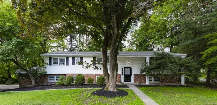 Welcome to this spacious 4-bedroom, 2.5-bathroom Raised Ranch that offers a perfect blend of comfort and modern living. Nestled on a wooded corner lot, this home boasts beautiful hardwood floors throughout the main level, creating a warm and inviting atmosphere. Step inside to discover a newly renovated kitchen, complete with sleek countertops, modern appliances, and ample cabinet space. The home includes two fully renovated bathrooms upstairs, including a primary en-suite. The half bath doubles as a laundry room, offering both comfort and functionality. The finished basement offers additional living space, perfect for a family room, home office, or guest suite. Outdoors, the two-tiered deck invites you to relax and enjoy the wooded surroundings, perfect for gatherings or peaceful moments. The large 2-car garage offers abundant storage and parking, adding to the convenience of this beautiful home. Don&rsquo;t miss the opportunity to own this thoughtfully updated gem in a prime location. Schedule your showing today!